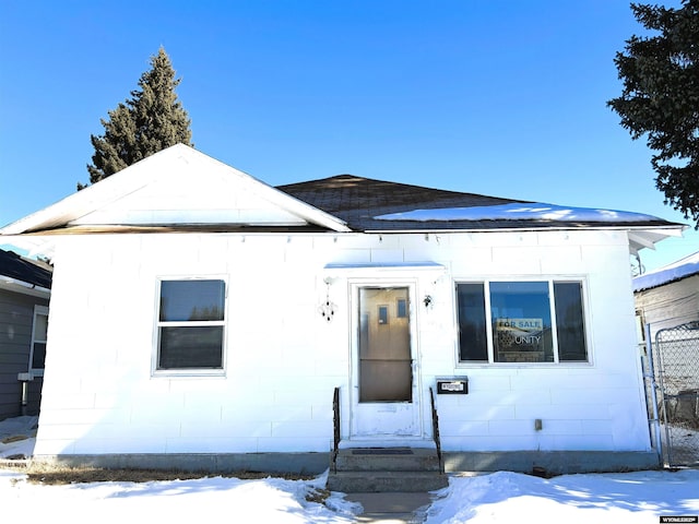 view of front of property featuring entry steps and concrete block siding