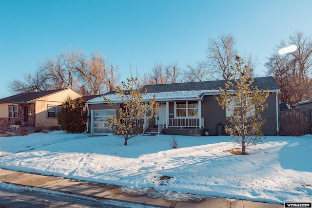 ranch-style house with a porch and an attached garage