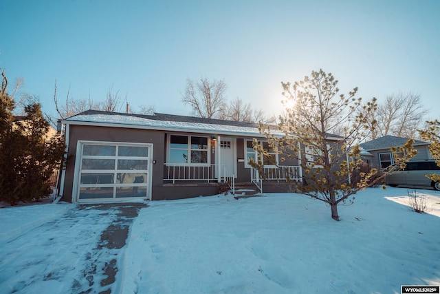 ranch-style house with covered porch and an attached garage