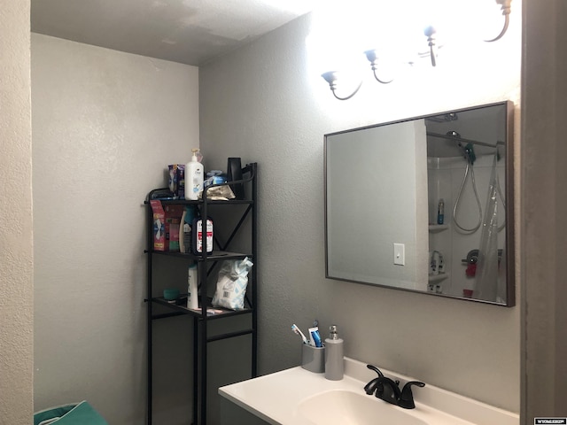 bathroom featuring a shower and vanity