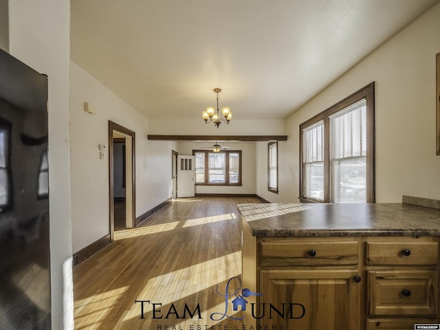 kitchen featuring hardwood / wood-style floors, a notable chandelier, and hanging light fixtures