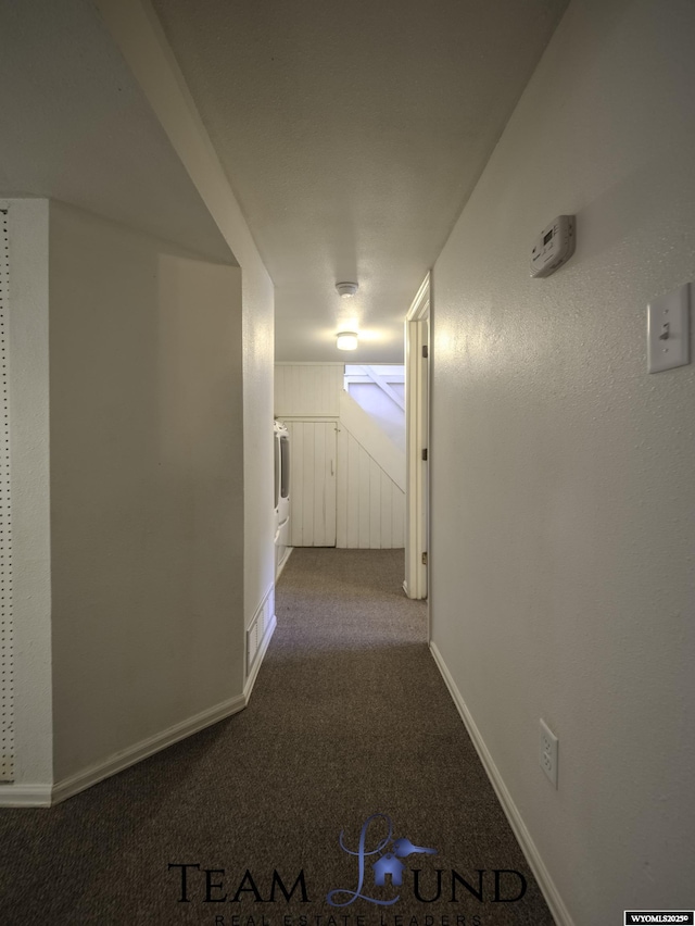 hall featuring carpet flooring