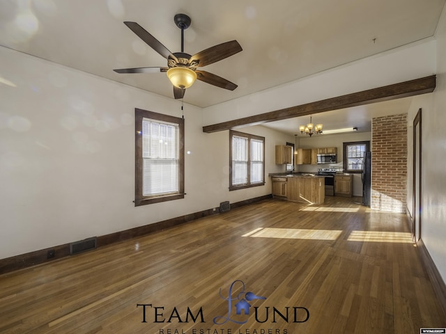 unfurnished living room featuring dark hardwood / wood-style flooring and ceiling fan with notable chandelier