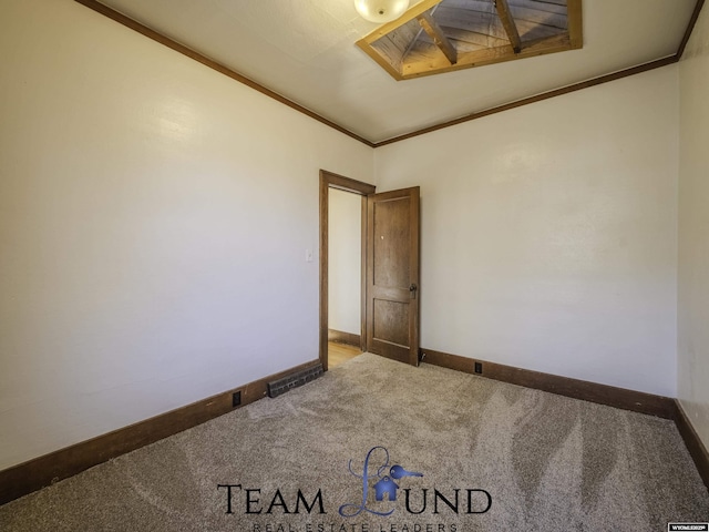 spare room featuring ornamental molding and carpet flooring