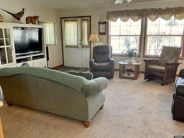 carpeted living room with ceiling fan