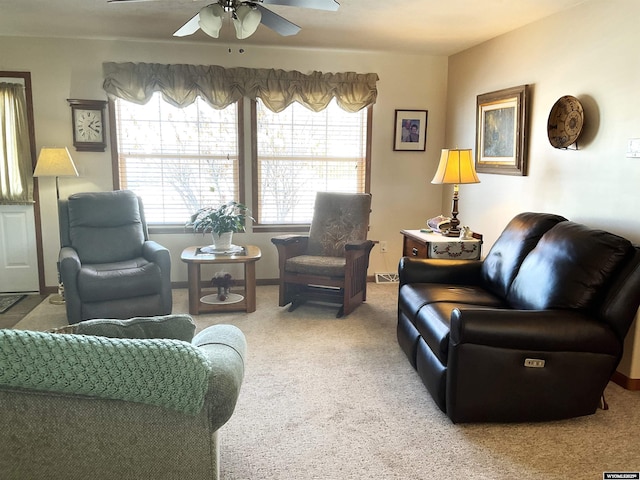 living room with ceiling fan, a healthy amount of sunlight, and carpet