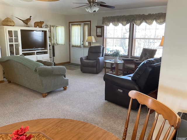 carpeted living room with ceiling fan