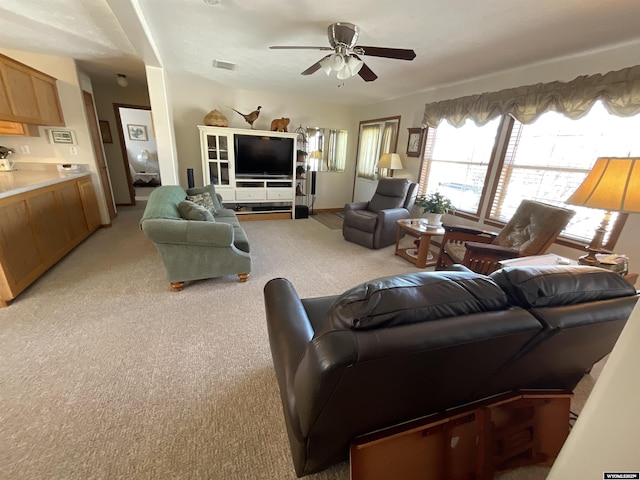 living room with light colored carpet and ceiling fan