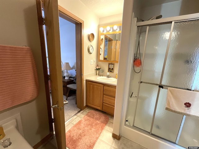 bathroom with vanity, tile patterned floors, and walk in shower