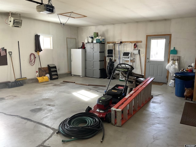 garage featuring a garage door opener and white fridge