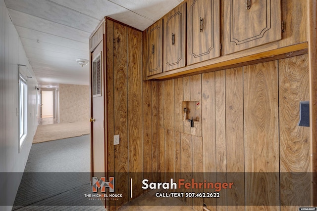 interior details with carpet and wood walls