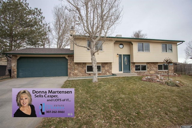 bi-level home featuring a garage and a front yard