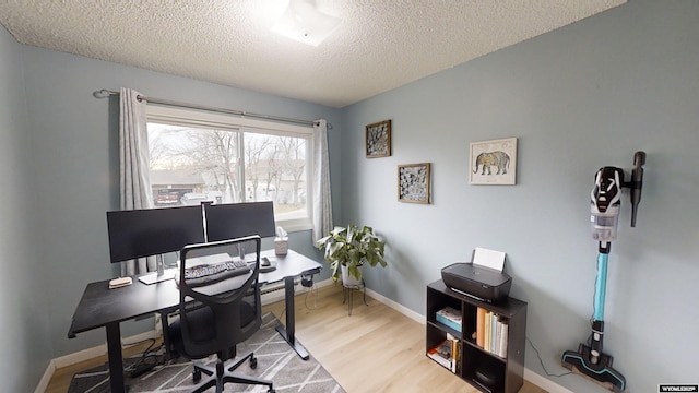 home office featuring wood-type flooring and a textured ceiling