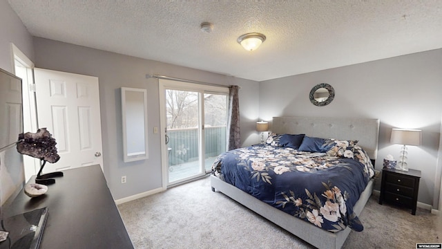 bedroom featuring a textured ceiling, carpet, and access to outside