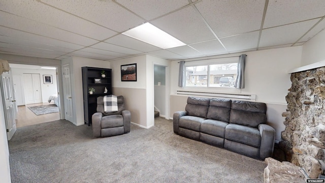 living room with carpet floors and a drop ceiling