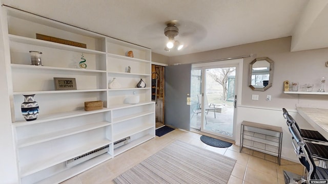 doorway to outside featuring light tile patterned floors and ceiling fan