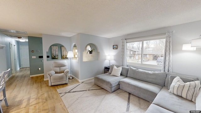 living room with hardwood / wood-style flooring and a textured ceiling