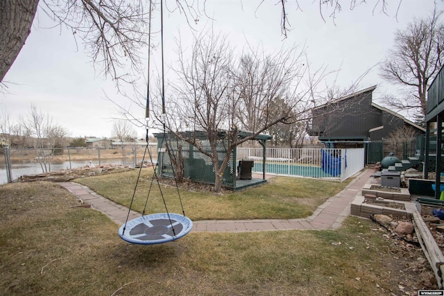 view of yard with a fenced in pool and an outbuilding