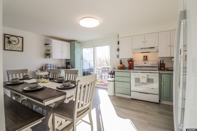 kitchen featuring white electric stove, white cabinets, light hardwood / wood-style floors, and green cabinetry