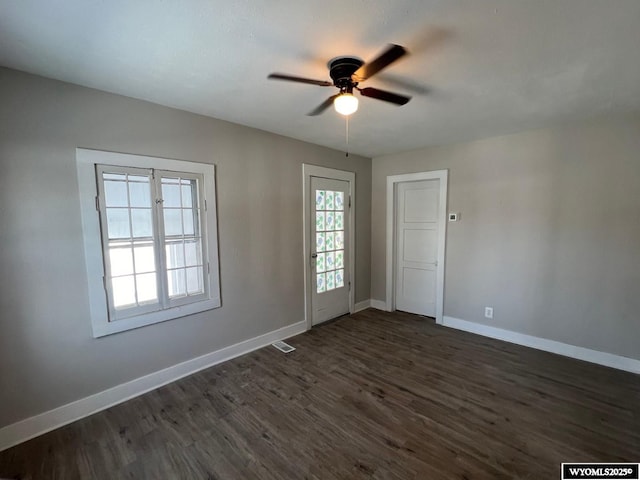 unfurnished room with ceiling fan and dark hardwood / wood-style flooring