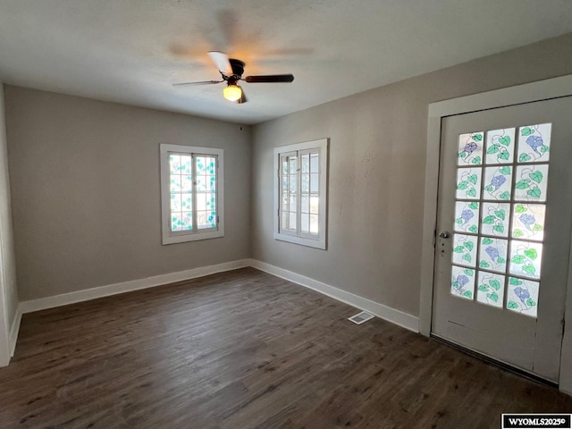 interior space with ceiling fan and dark hardwood / wood-style floors