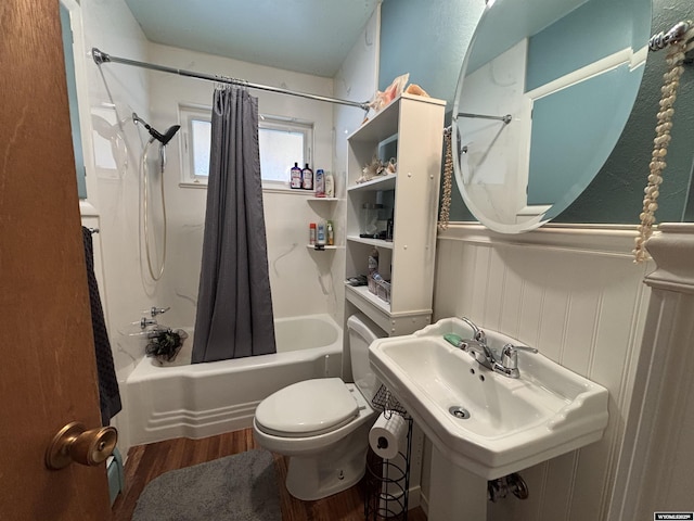 full bathroom featuring sink, toilet, hardwood / wood-style floors, and shower / bath combo with shower curtain