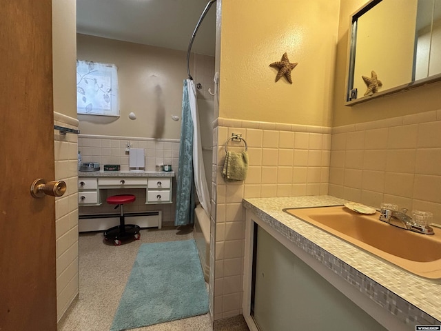 bathroom featuring vanity, tile walls, baseboard heating, and shower / bath combo with shower curtain