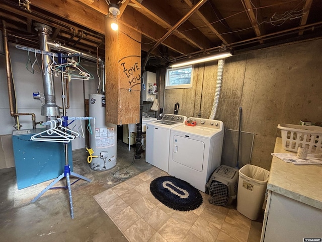 basement with water heater and independent washer and dryer