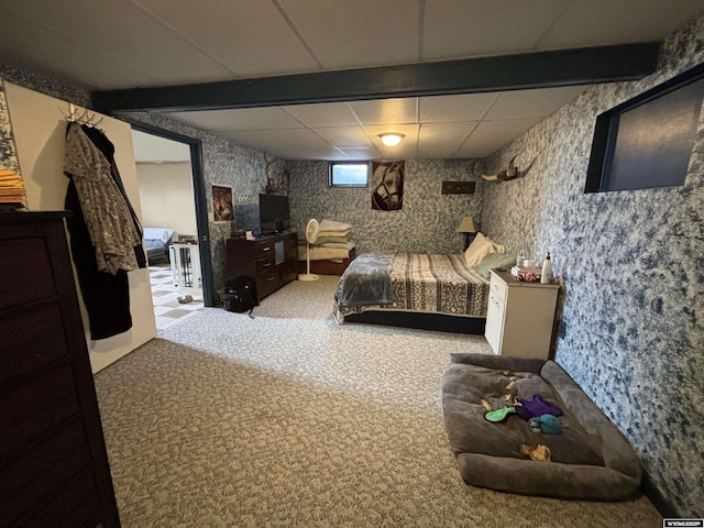 carpeted bedroom with a paneled ceiling