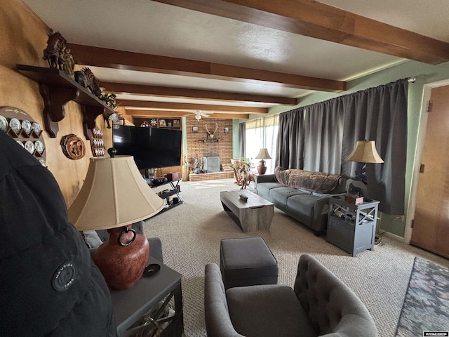 living room featuring light colored carpet, beam ceiling, and a fireplace