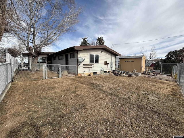 back of house with a lawn