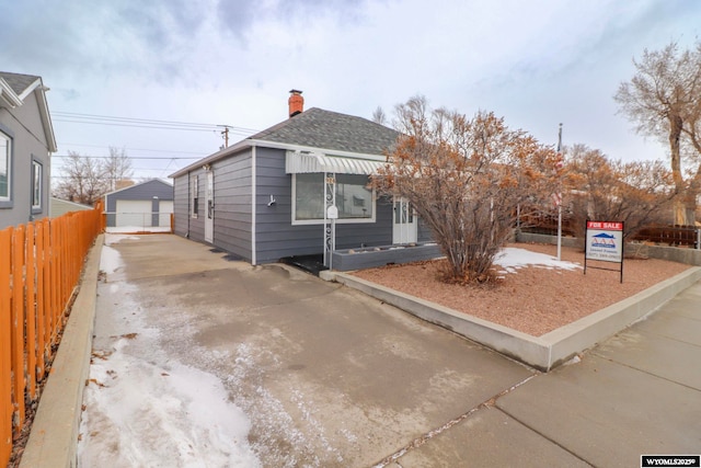 view of front of property with a garage and an outdoor structure