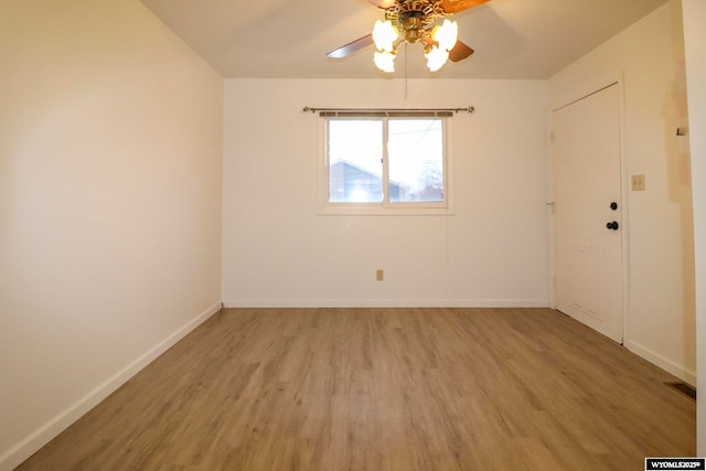 empty room with ceiling fan and light hardwood / wood-style floors