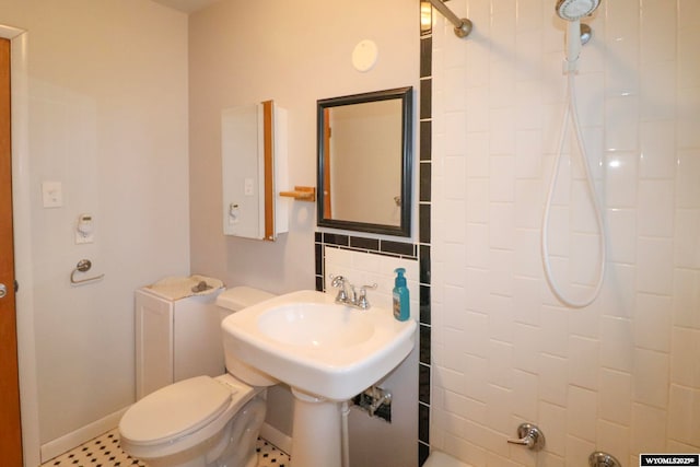 bathroom with tasteful backsplash, a shower, and toilet