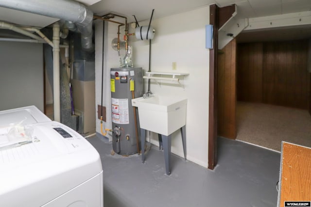 washroom with separate washer and dryer, gas water heater, and wood walls