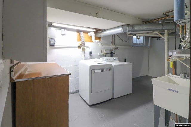 laundry area featuring washing machine and dryer and sink