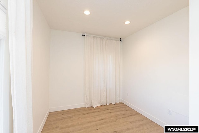 empty room with light hardwood / wood-style flooring