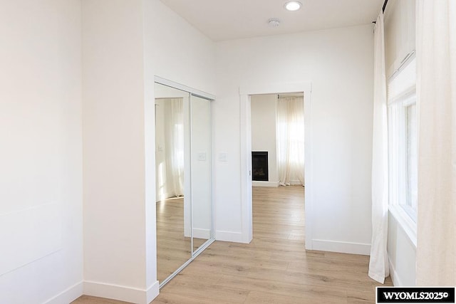 hall featuring a wealth of natural light and light wood-type flooring