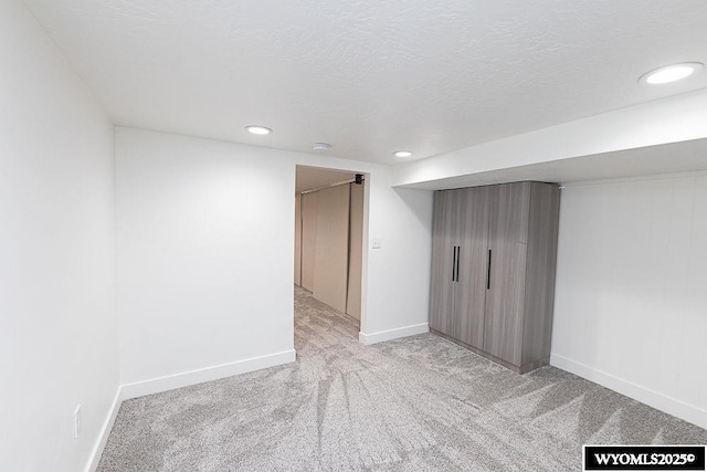 carpeted spare room featuring a textured ceiling