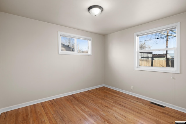 spare room with light hardwood / wood-style floors