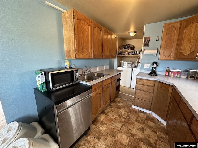 kitchen featuring separate washer and dryer and sink