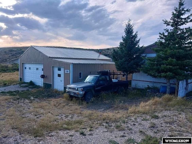 view of garage at dusk