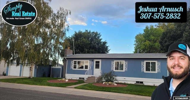 view of front of house with a garage and a front lawn