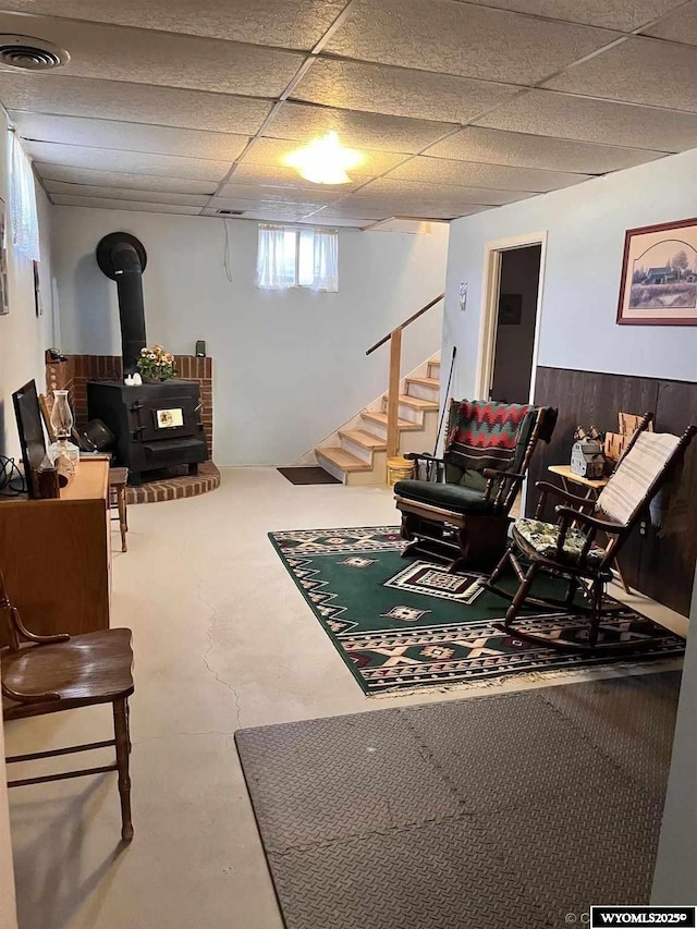 interior space featuring a wood stove and a paneled ceiling