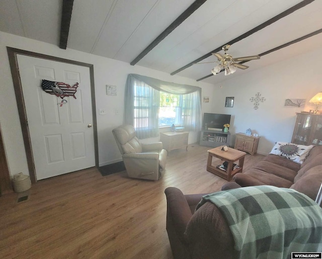 living room featuring lofted ceiling with beams, hardwood / wood-style floors, and ceiling fan