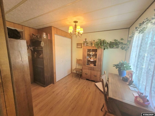 office with a chandelier and light hardwood / wood-style floors