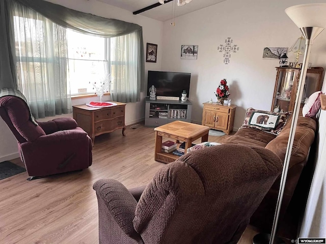 living room featuring ceiling fan, lofted ceiling, and wood-type flooring