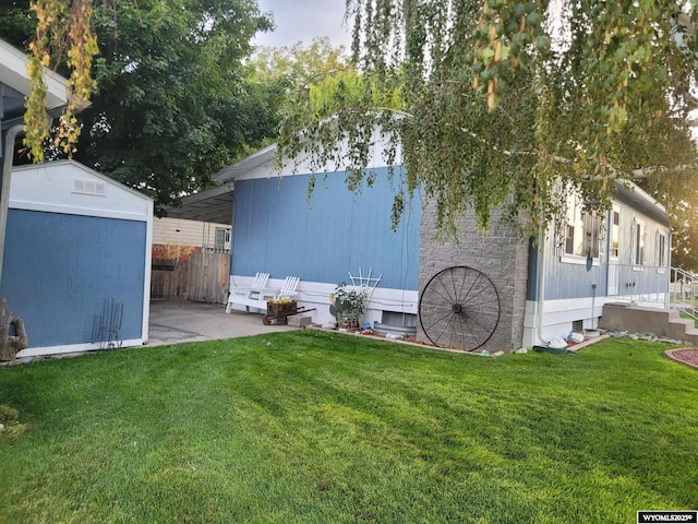 view of yard with a carport and a storage unit