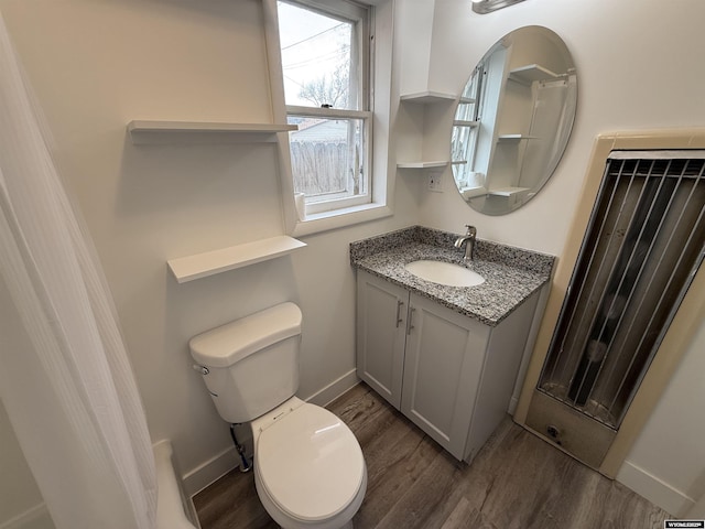 bathroom with vanity, hardwood / wood-style floors, and toilet