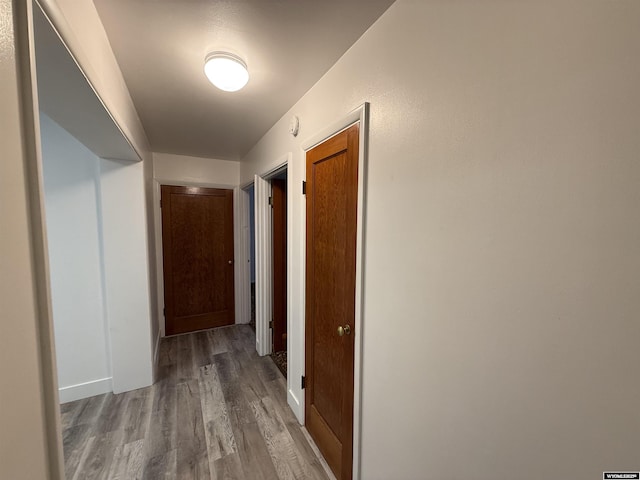 corridor with hardwood / wood-style floors